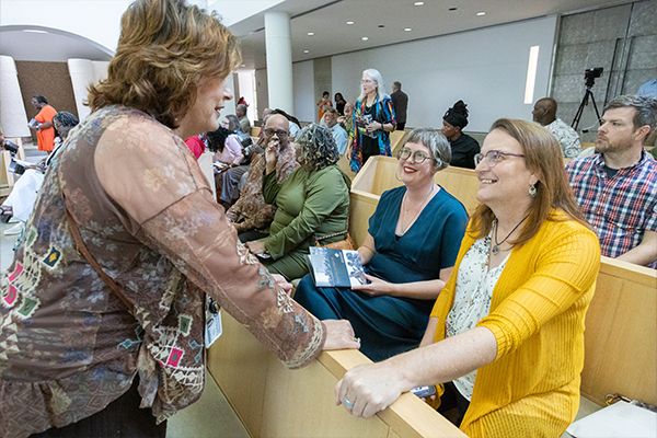 Dr. Helene Russell greets students and families at the 2024 Baccalaureate Chapel Service