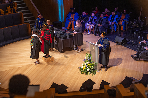 Students getting hooded as part of the 2024 Commencement Ceremony